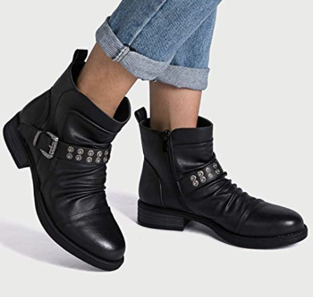 model wearing black booties with a buckle design