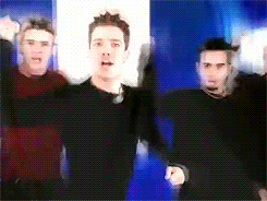NSYNC doing the hand in the air fist pump movement