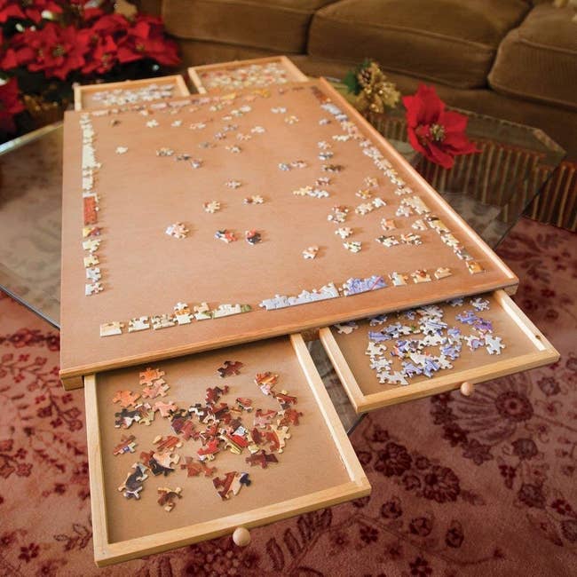 tabletop with drawers that pull out in separated groups of puzzle pieces
