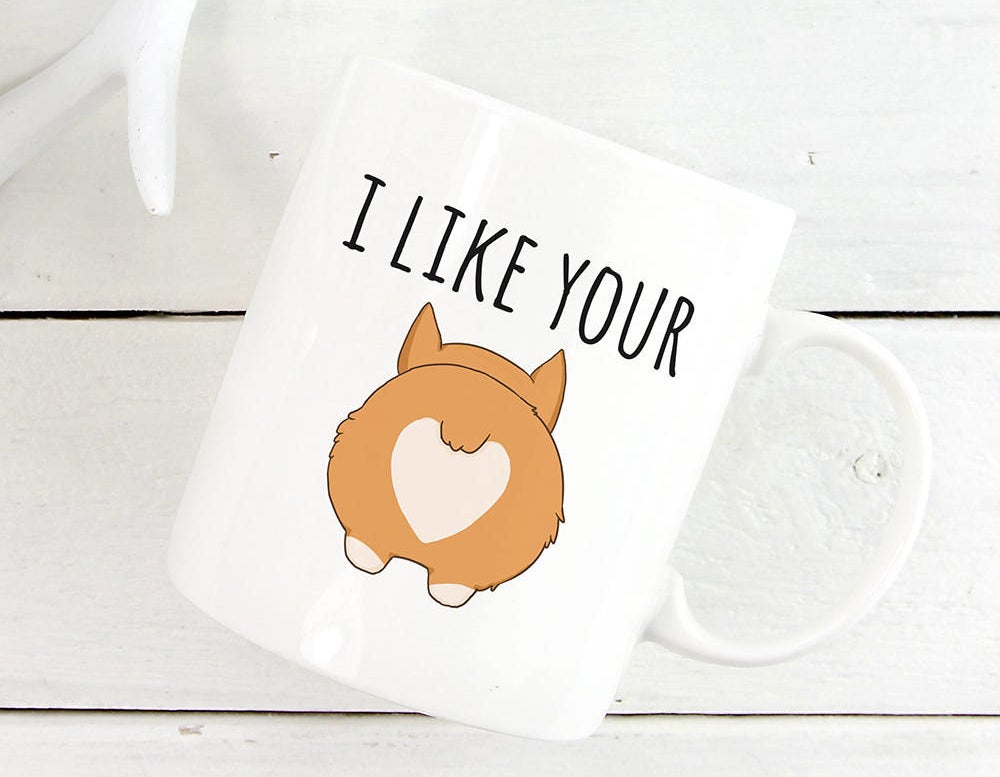The mug with text "I like your" and an illustration of a corgi butt on it