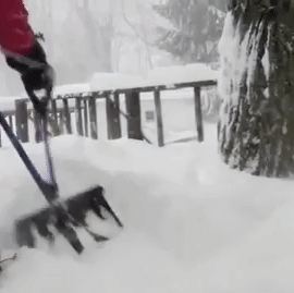 gif of person using dual-handled snow shovel