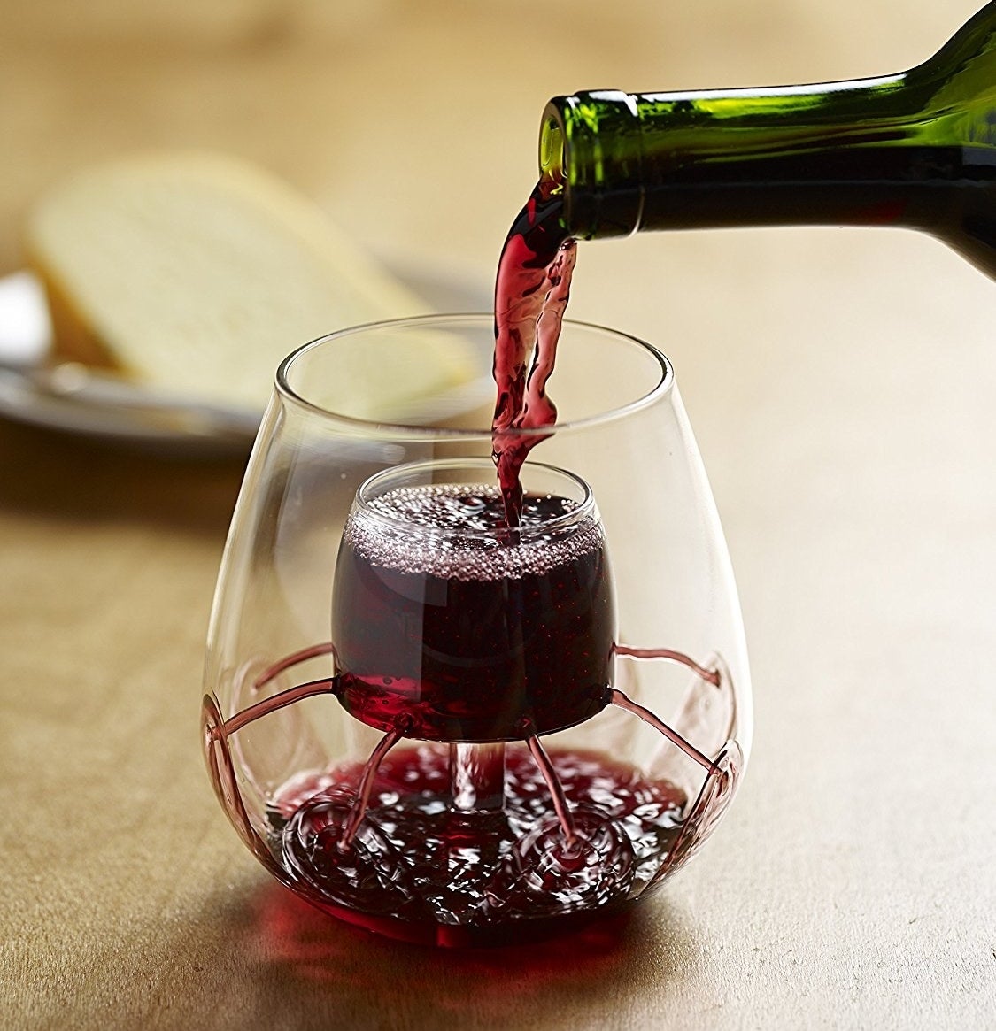 Aerating wine glasses with red wine in them 