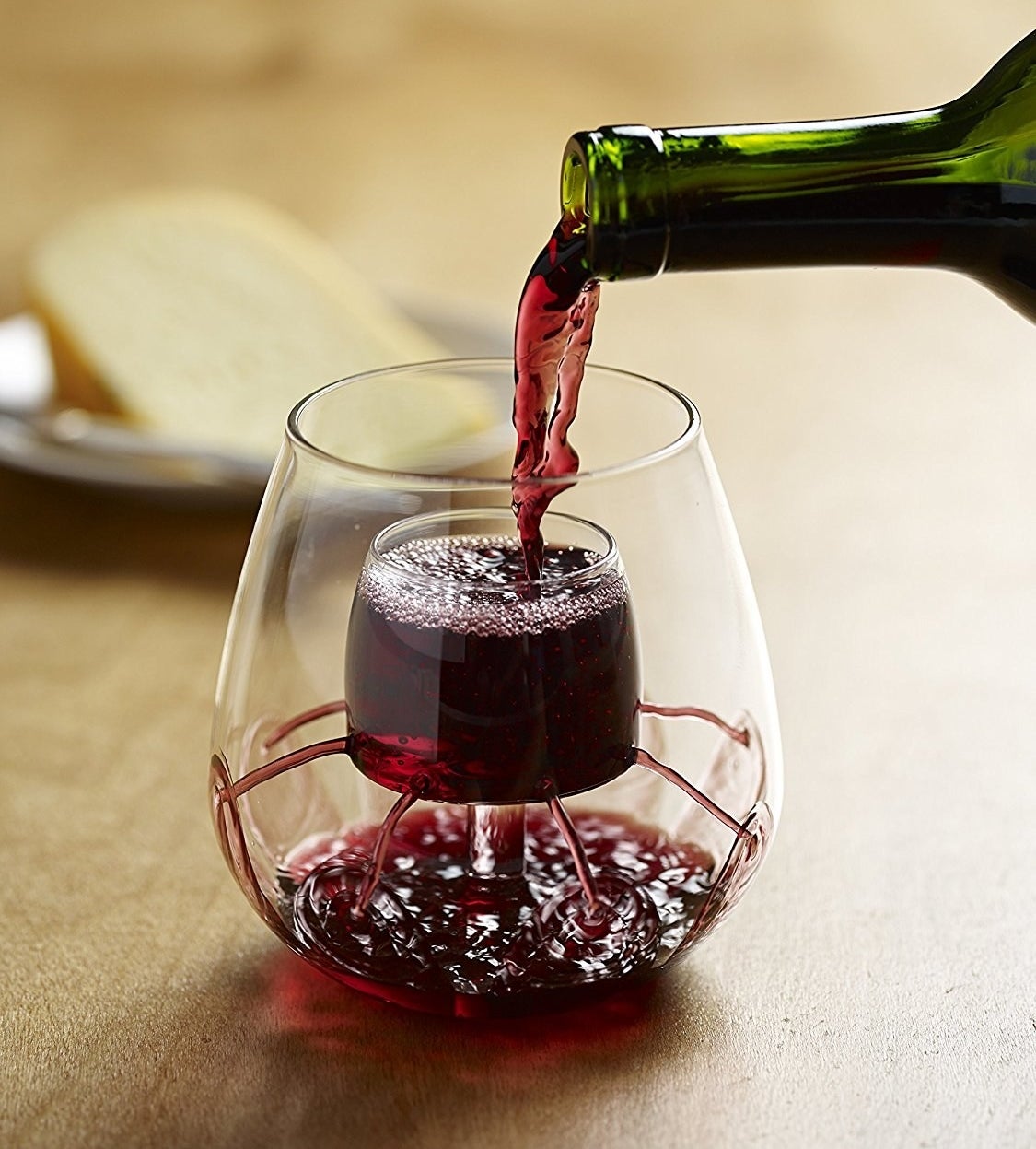 Aerating wine glasses with red wine in them 
