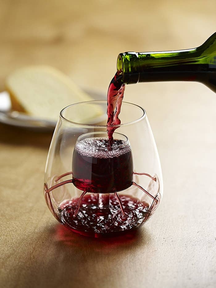 Aerating wine glasses with red wine in them 