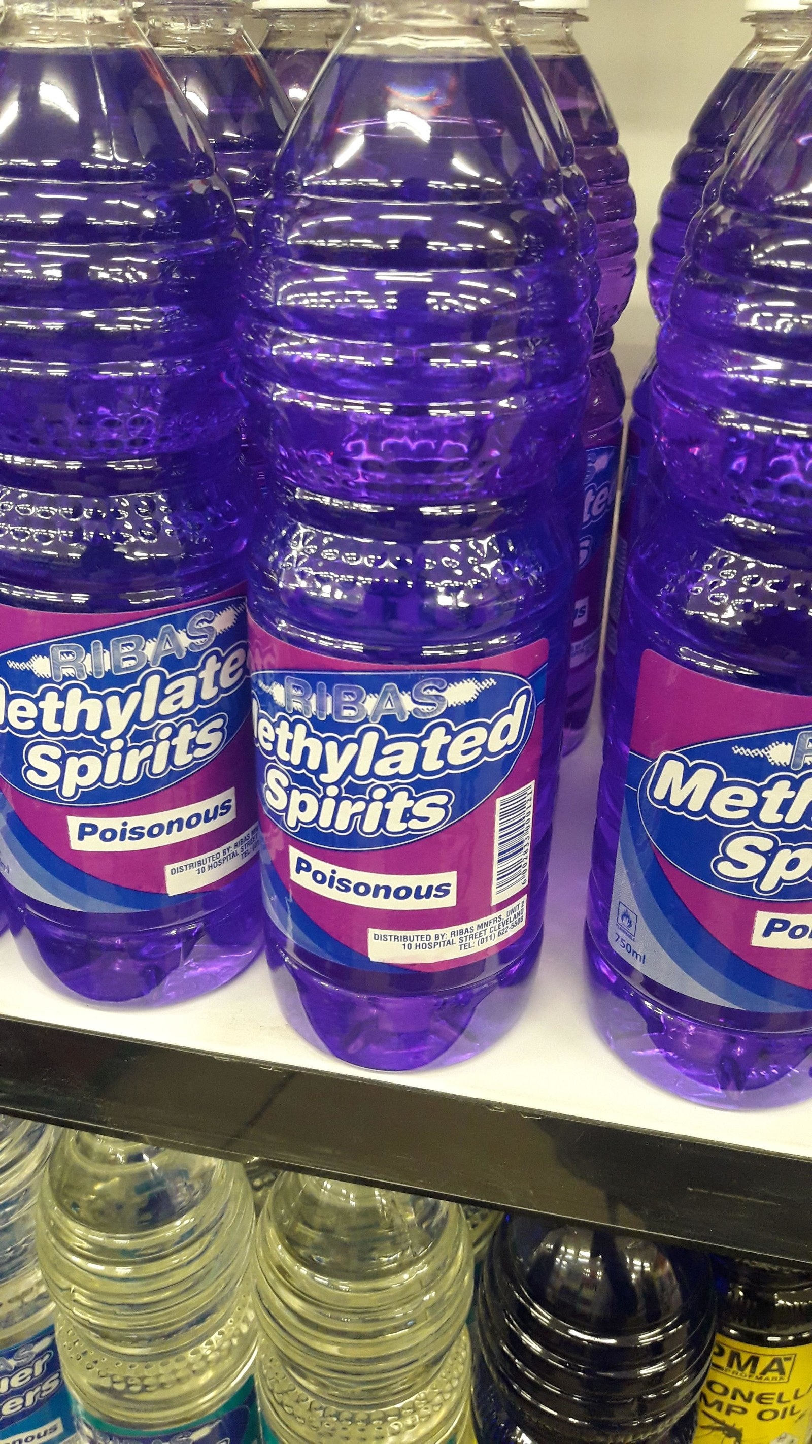 bottled blue liquid labeled Methylated Spirits - poisonous