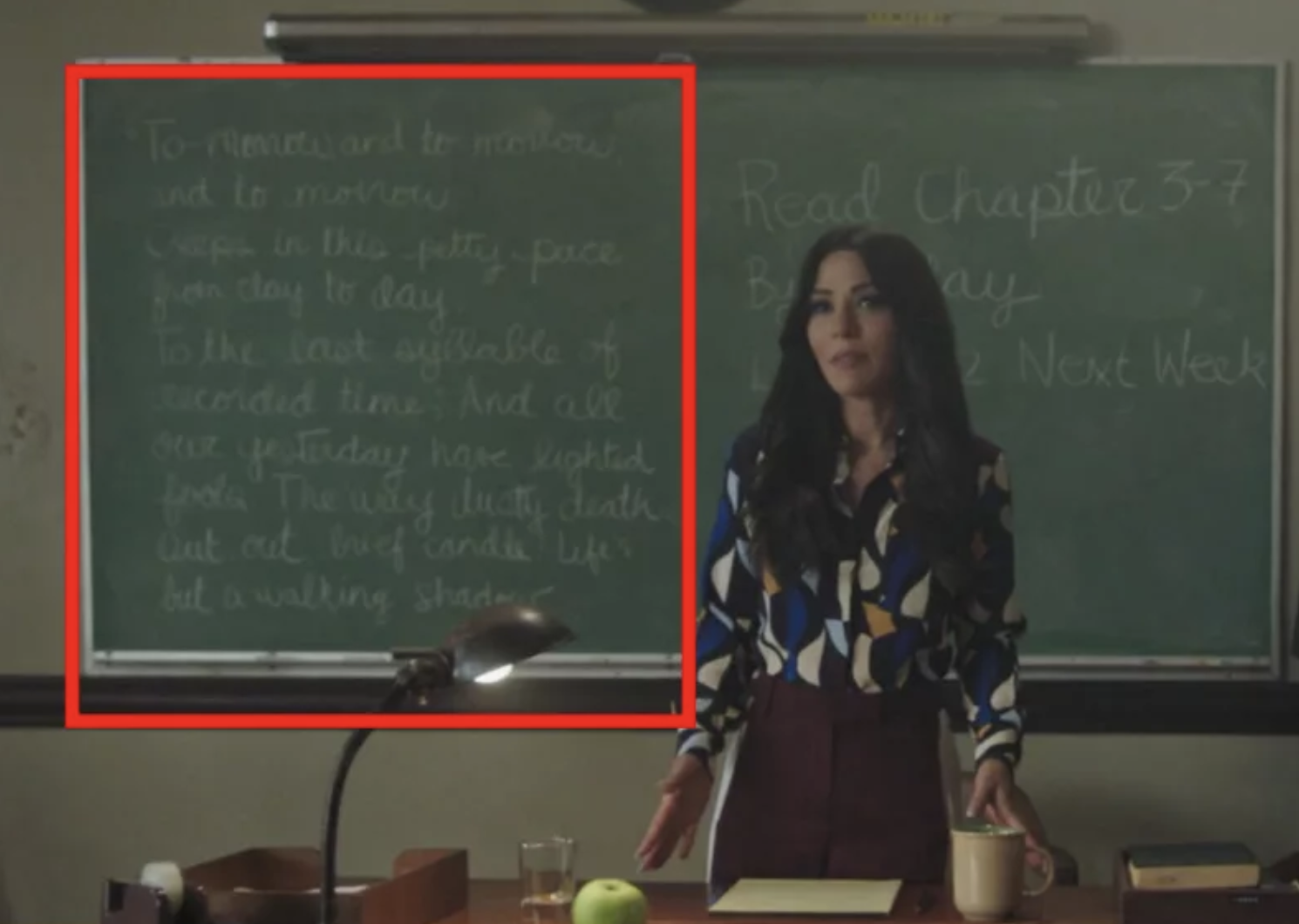 The full quote on the blackboard reads: "Tomorrow, and tomorrow, and tomorrow / Creeps in this petty pace from day to day / To the last syllable of recorded time, / And all our yesterdays have lighted fools / The way to dusty death. Out, out, brief candle! / Life’s but a walking shadow."
