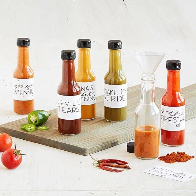 a variety of the different hot sauces created with the kit