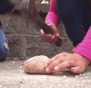 gif of person using a hammer to break open a geode