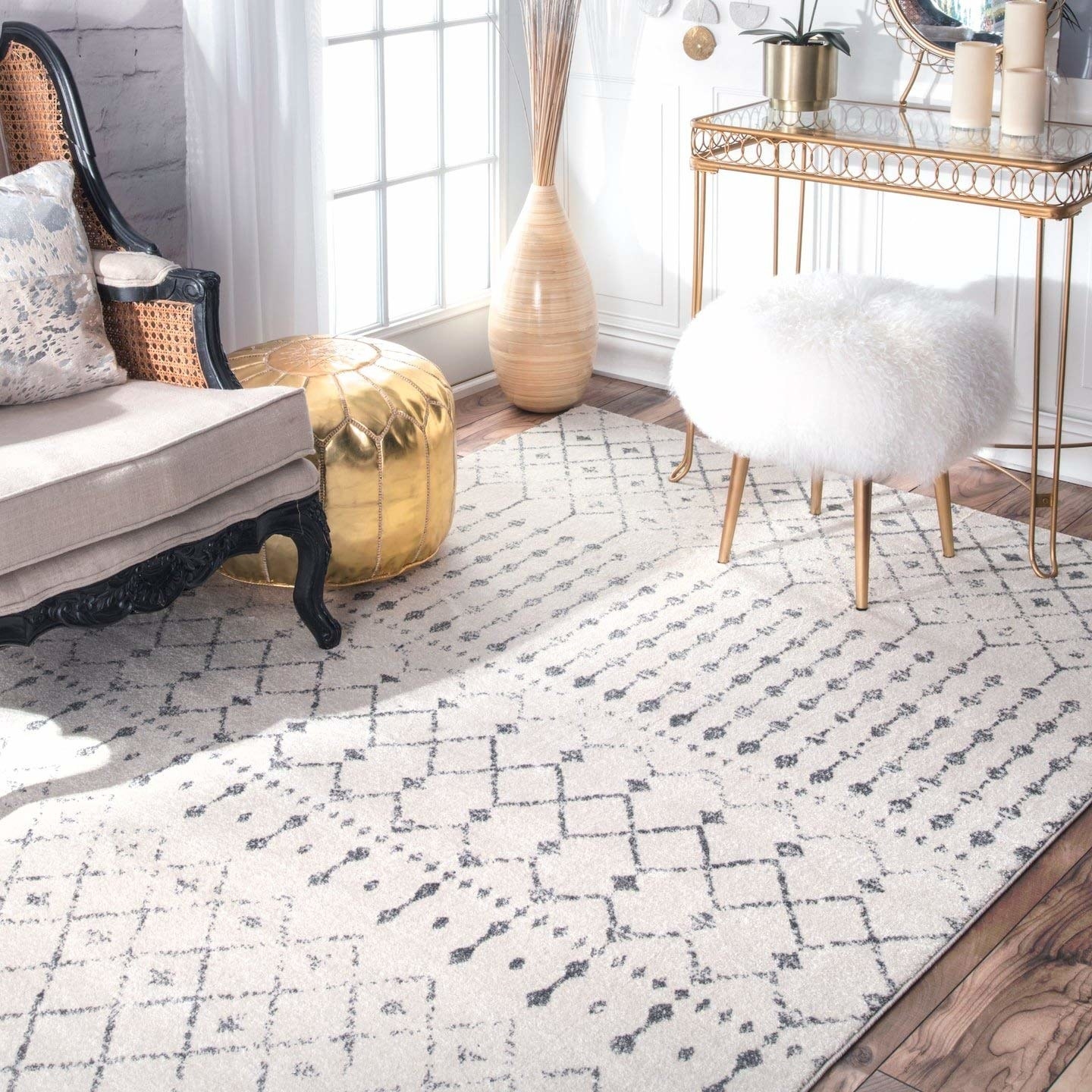 the square rug in white and gray with geometric shapes and line designs on it 