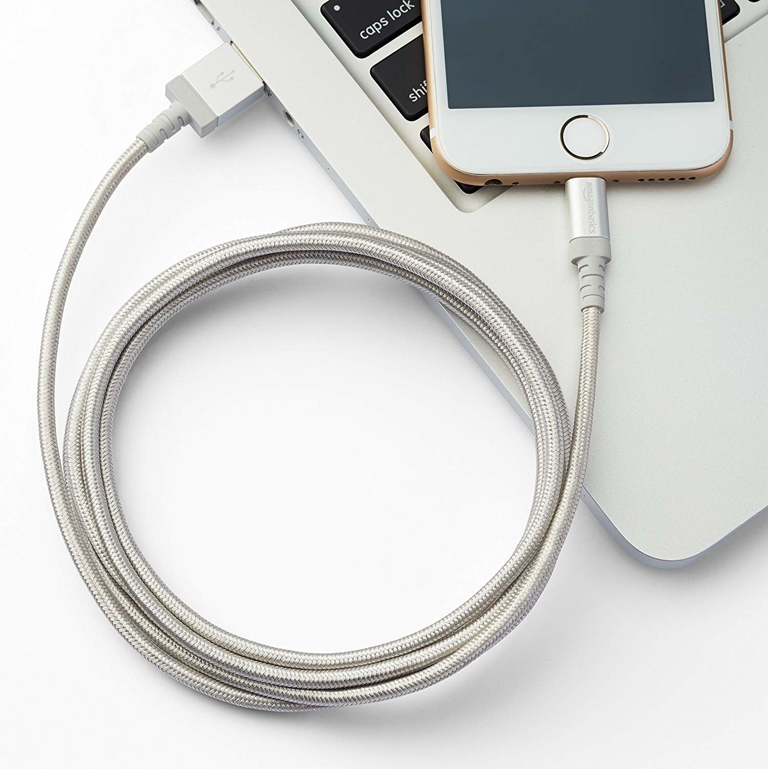 Silver charging cable charging an iPhone through a laptop