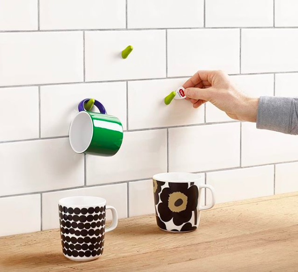 kitchen tile backsplash and wood countertop with Sugru-made clay hooks mounted on wall for hanging up coffee mugs