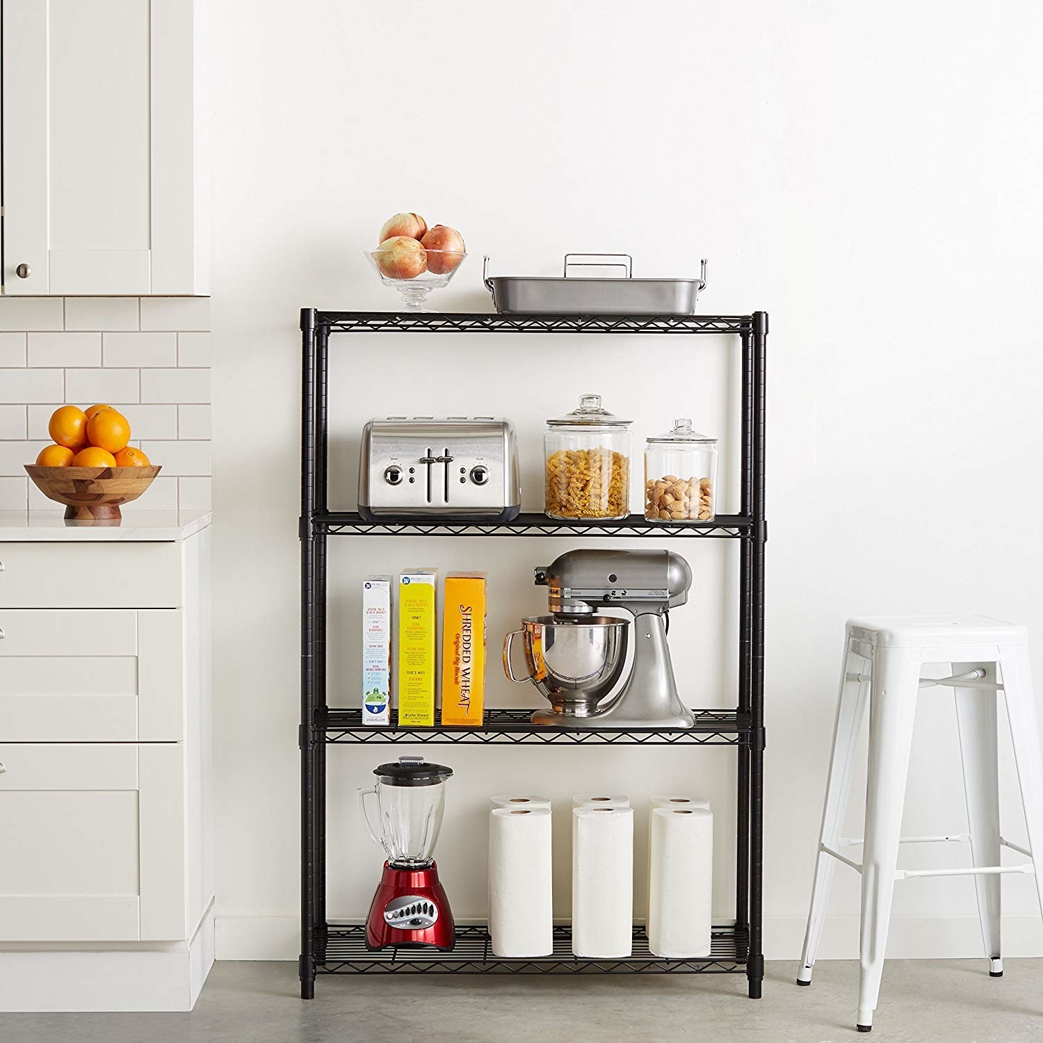 the shelves in black holding a blender, a stand mixer, a toaster, cereals, jars, and other items