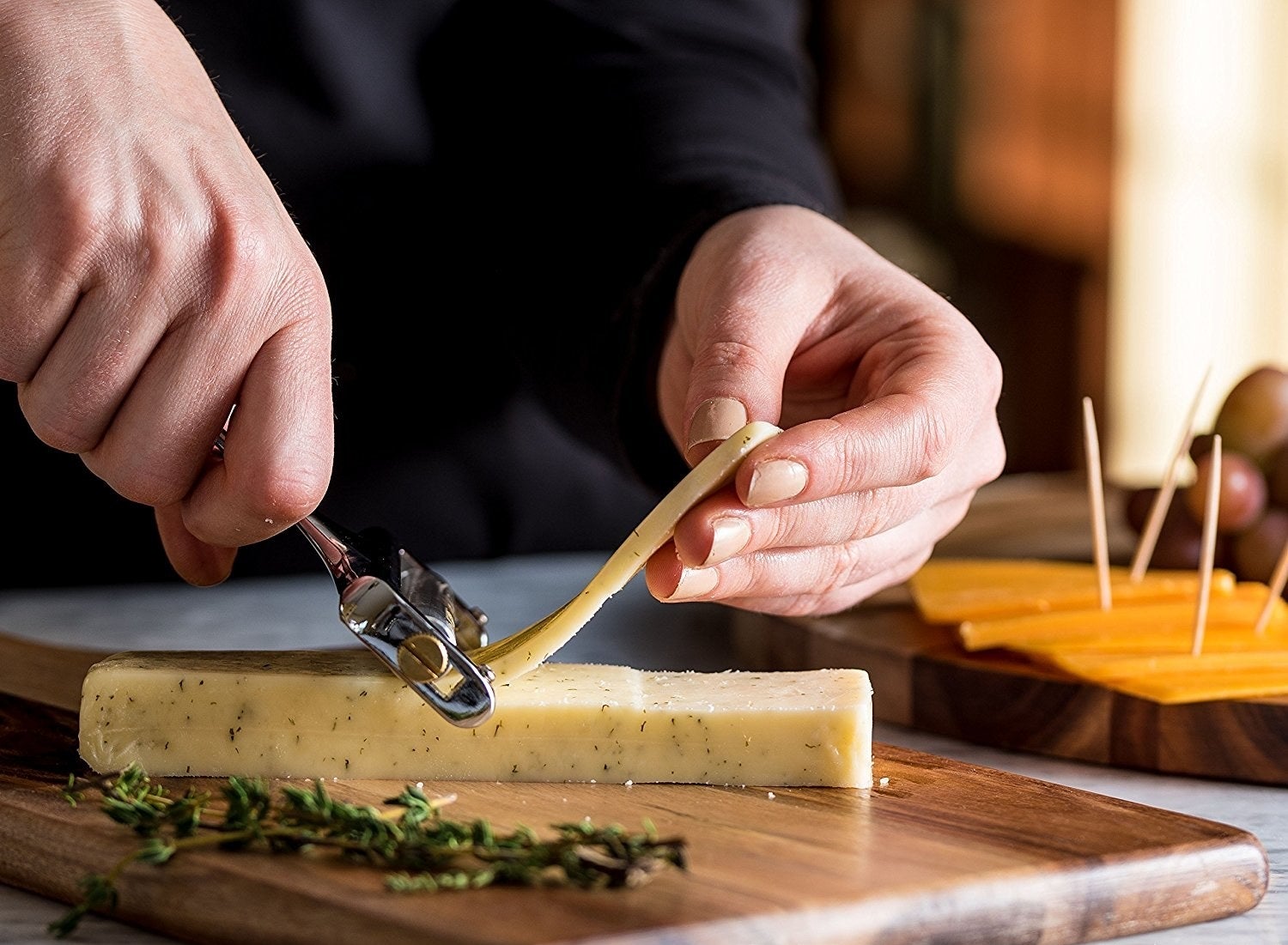 A model slicing cheese from a block with the stainless steel slicer 