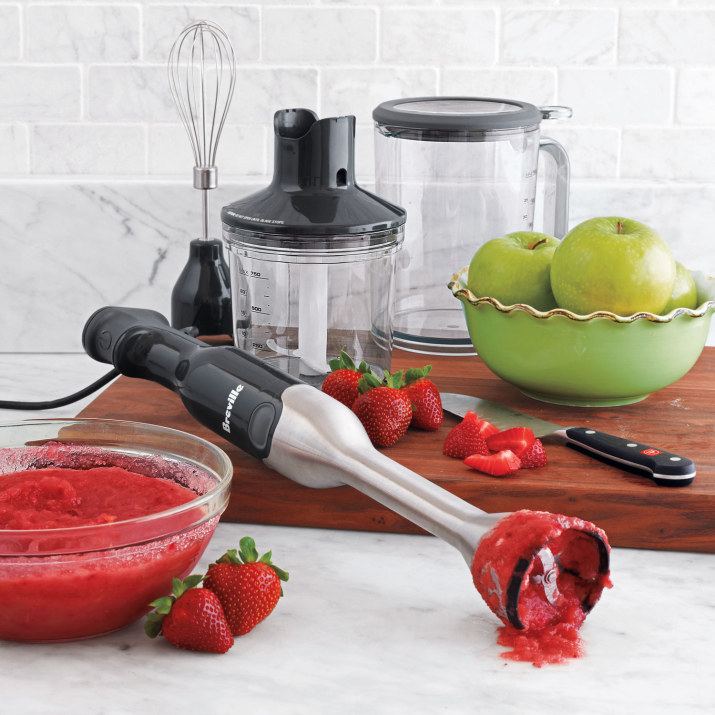 The blender in the process of blending some strawberries