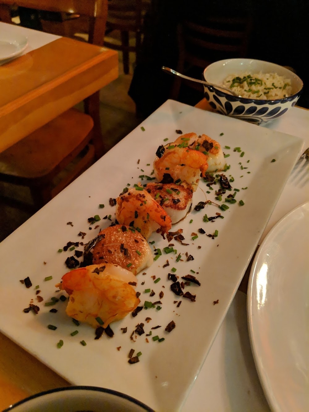 Juicy, plump pieces of seared scallops and jumbo shrimp are served with a creamy habanero sauce. The entree is complemented by white rice with cilantro and thick black bean sauce. Both the scallops and shrimps pack an explosion of flavors.