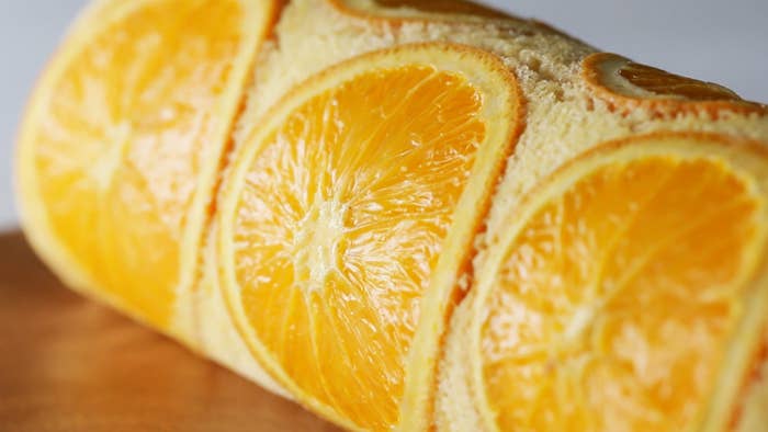 Orange Swiss Roll CakeServings: 4INGREDIENTS3 medium eggs, separated100 grams granulated sugar, divided50 milliliters milk50 milliliters vegetable oil70 grams all-purpose flour5 medium orange slices200 milliliters heavy cream1 medium orange, peeled and cut into segmentsPREPARATIONPreheat the oven to 350˚F (180˚C). Line a 9-inch square baking dish with parchment paper.In a medium bowl, beat the egg whites with an electric hand mixer on medium speed until foamy. Add 50 grams of granulated sugar in 2 additions, and beat until medium peaks form. In a separate medium bowl, add the egg yolks and 30 grams of granulated sugar and beat with an electric hand mixer until pale. Add the milk and oil and whisk to combine, then sift in the flour and stir until well-combined. Add ⅔ of the whipped egg whites and gently fold until combined. Add the rest of the egg whites and fold to combine. Arrange the orange slices in the center of the prepared baking dish, then pour the batter on top. Spread evenly with a spatula.Bake for 15 minutes until cooked. Let cool to room temperature. Remove the cake from the pan using the parchment paper.In a medium bowl, beat the heavy cream and remaining 20 grams of granulated sugar with an electric hand mixer until soft peaks form. Spread the whipped cream evenly over the cooled cake. Arrange the orange segments in 2 lines at the bottom center of the cake. Starting from the bottom, gently roll into a log.Chill in the fridge for at least 1 hour, then slice and serve.Enjoy!