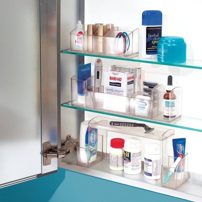 inside a medicine cabinet with clear plastic organizers