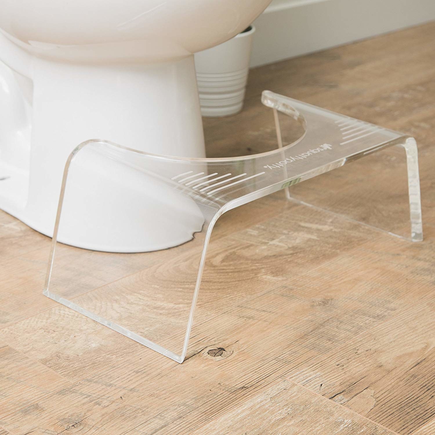 clear stool in front of a toilet