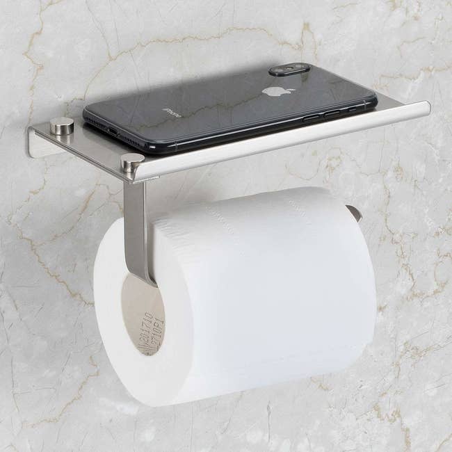 toilet paper holder with a stainless-steel shelf on top that's large enough to put down a phone