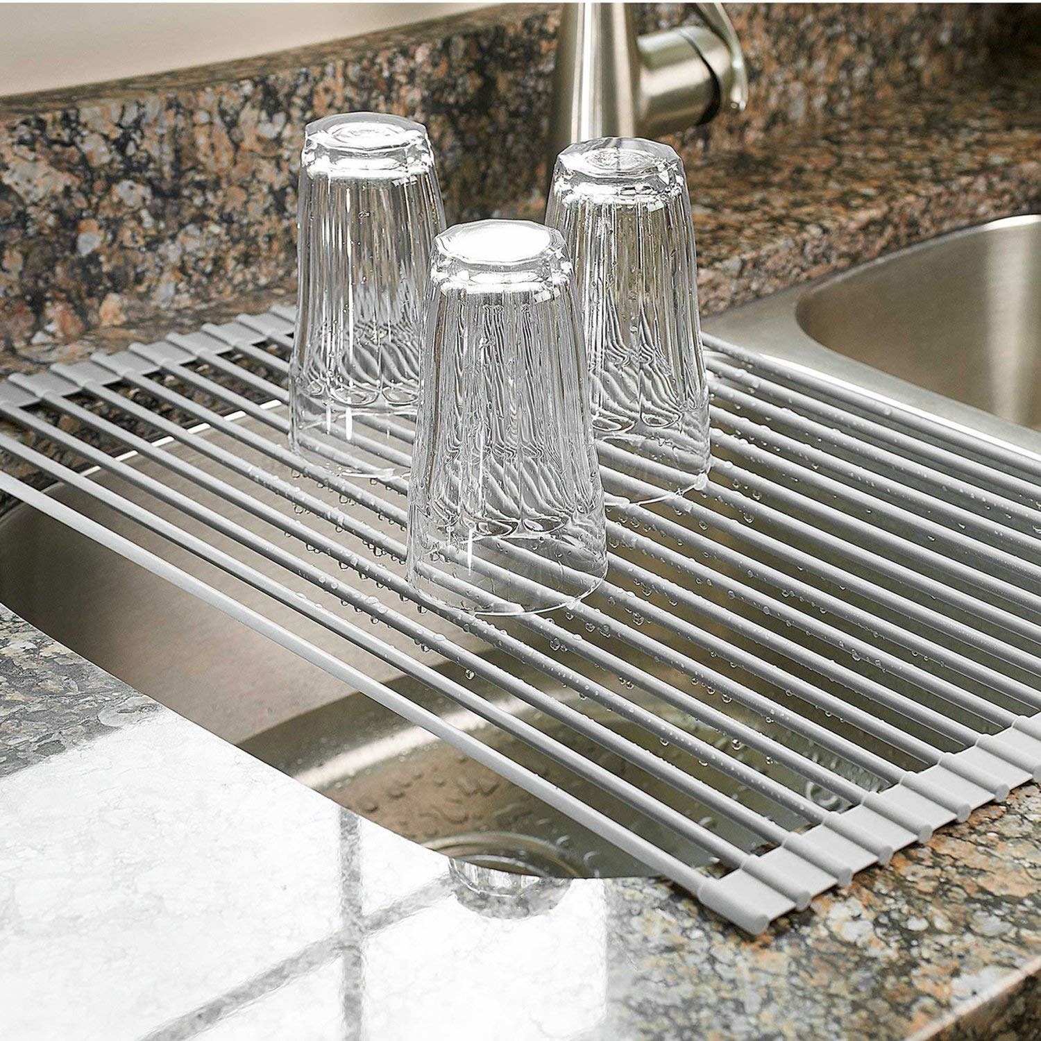 An over-the-sink drying rack with three drinking glasses on it