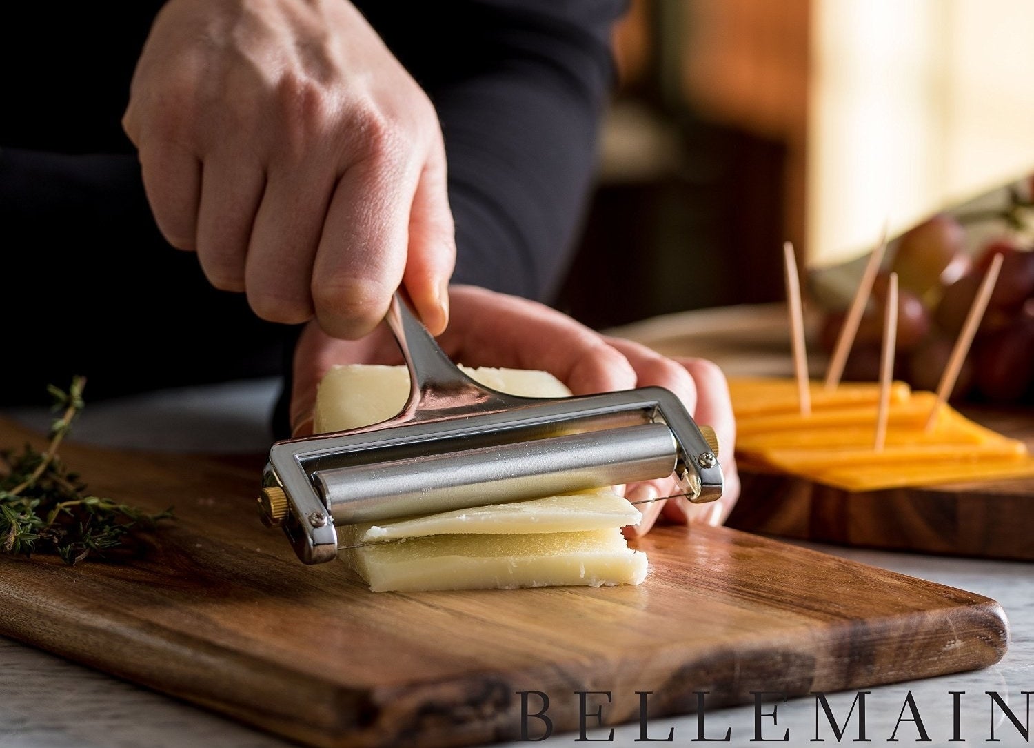 a pair of hands using the cheese slicer