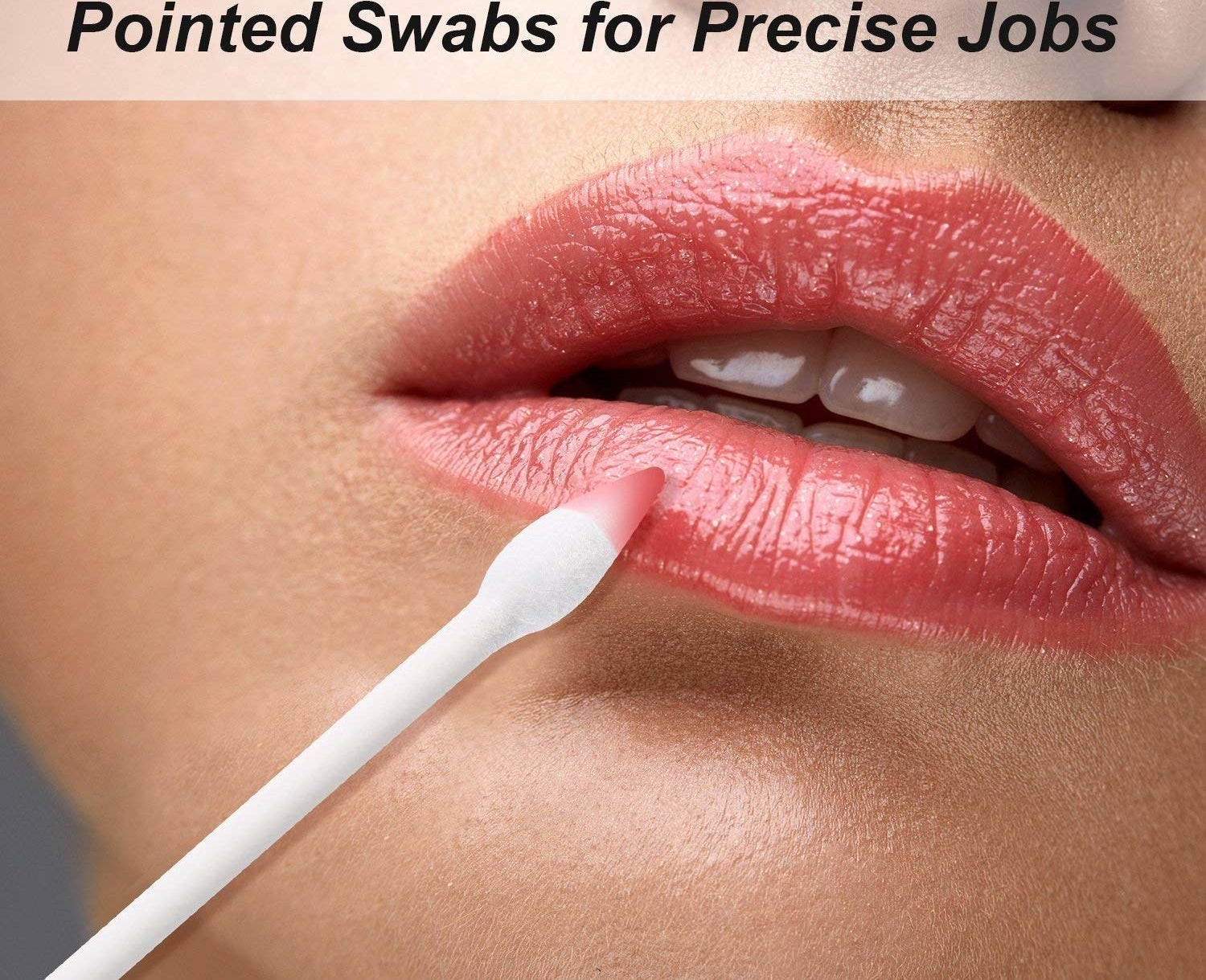 Model using the double-tipped cotton swab to fix their lipstick 