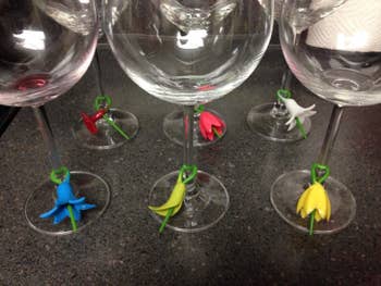 the wine charms on the bottom of several wine glasses