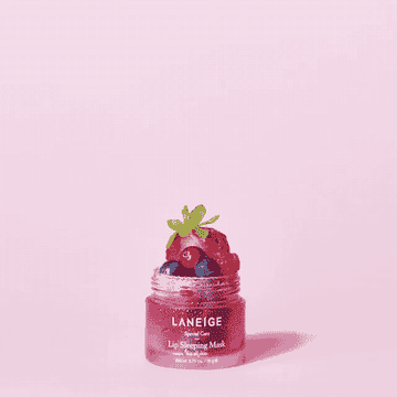 a gif of a model snapping and berries appearing in a pink lip mask container