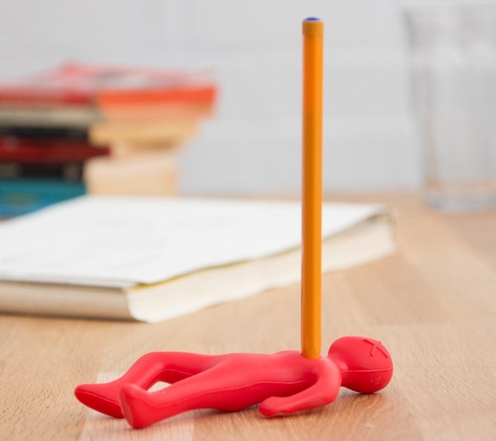 the dramatic pen holder that looks like a person being stabbed by a pen