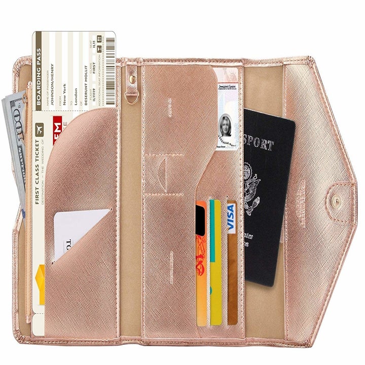 The rose gold wallet open to show everything it can hold