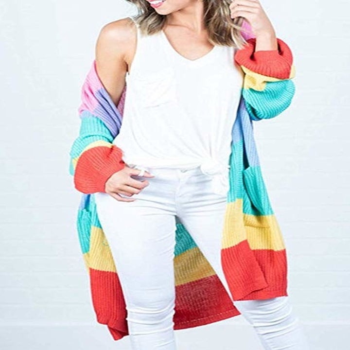 model wearing striped cardigan with bright rainbow colors