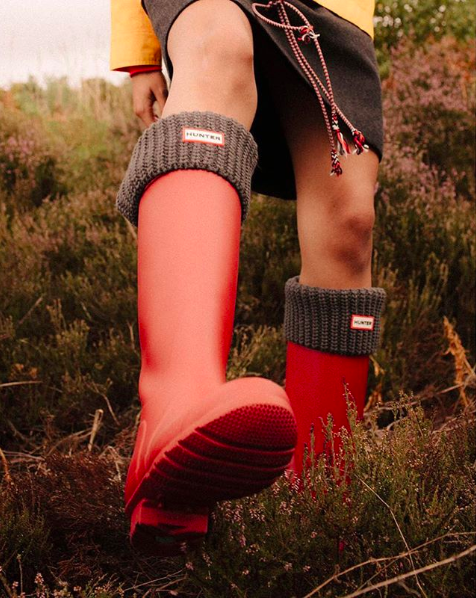 model wearing red rain boots