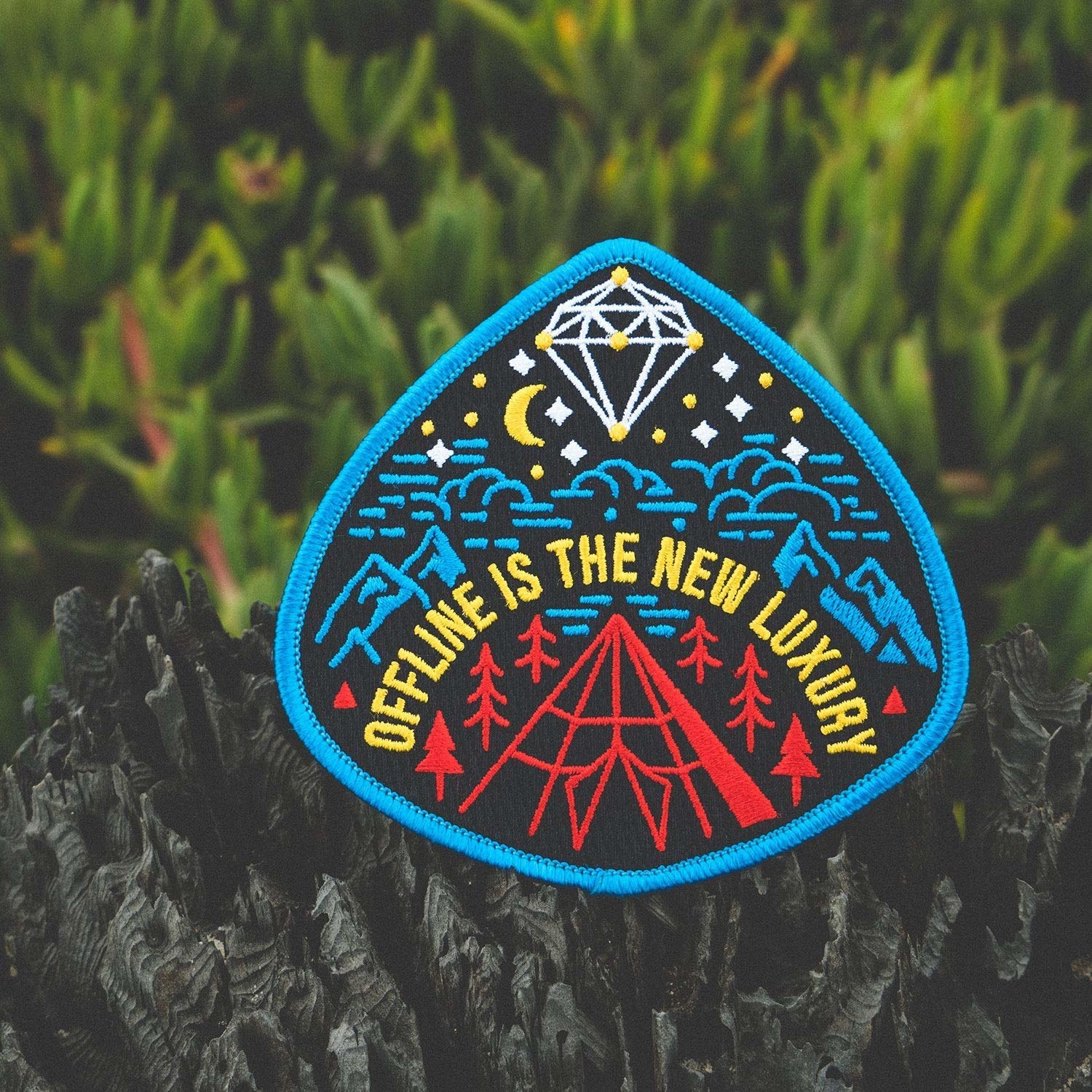 patch with mountain illustration that says &quot;offline is the new luxury&quot; 