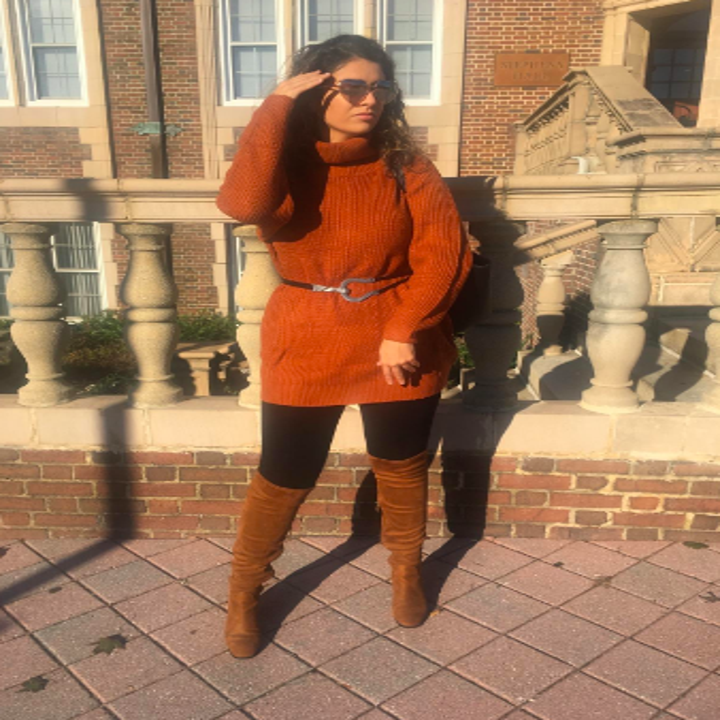 Different reviewer wearing sweater in orange with belt