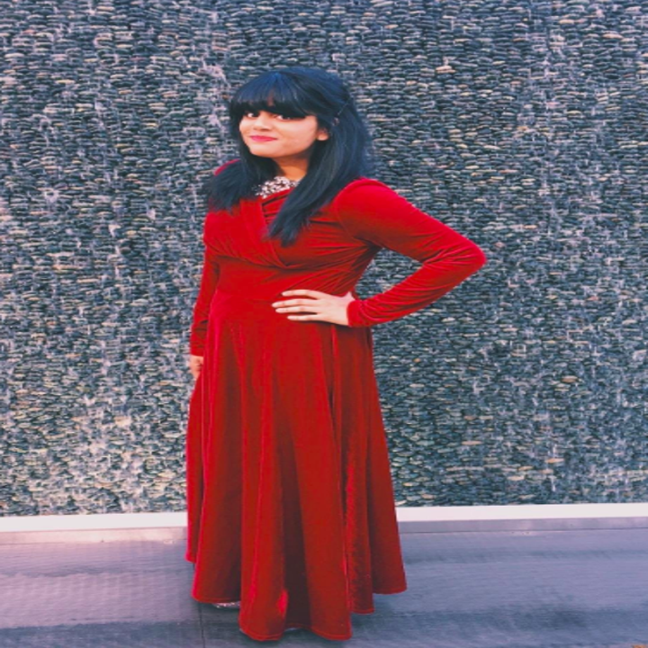 A reviewer wearing the dress in red