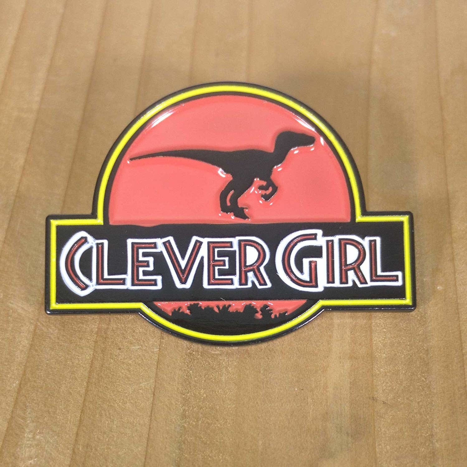 The jurassic park-inspired pin with a raptor that says &quot;clever girl&quot;
