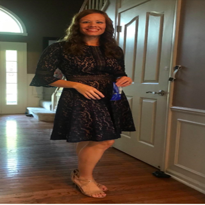 A reviewer wearing the dress with flared three-quarter length sleeves in navy