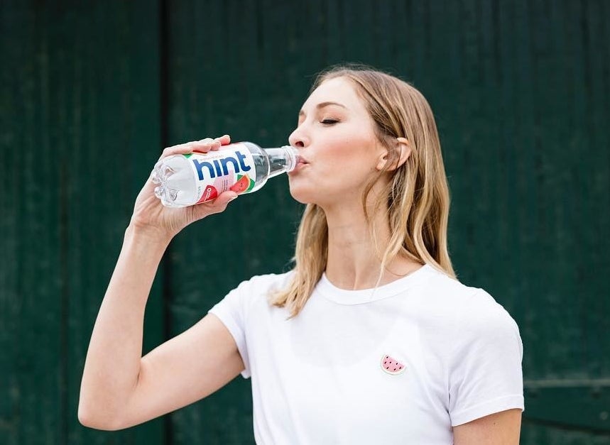 model drinking a bottle