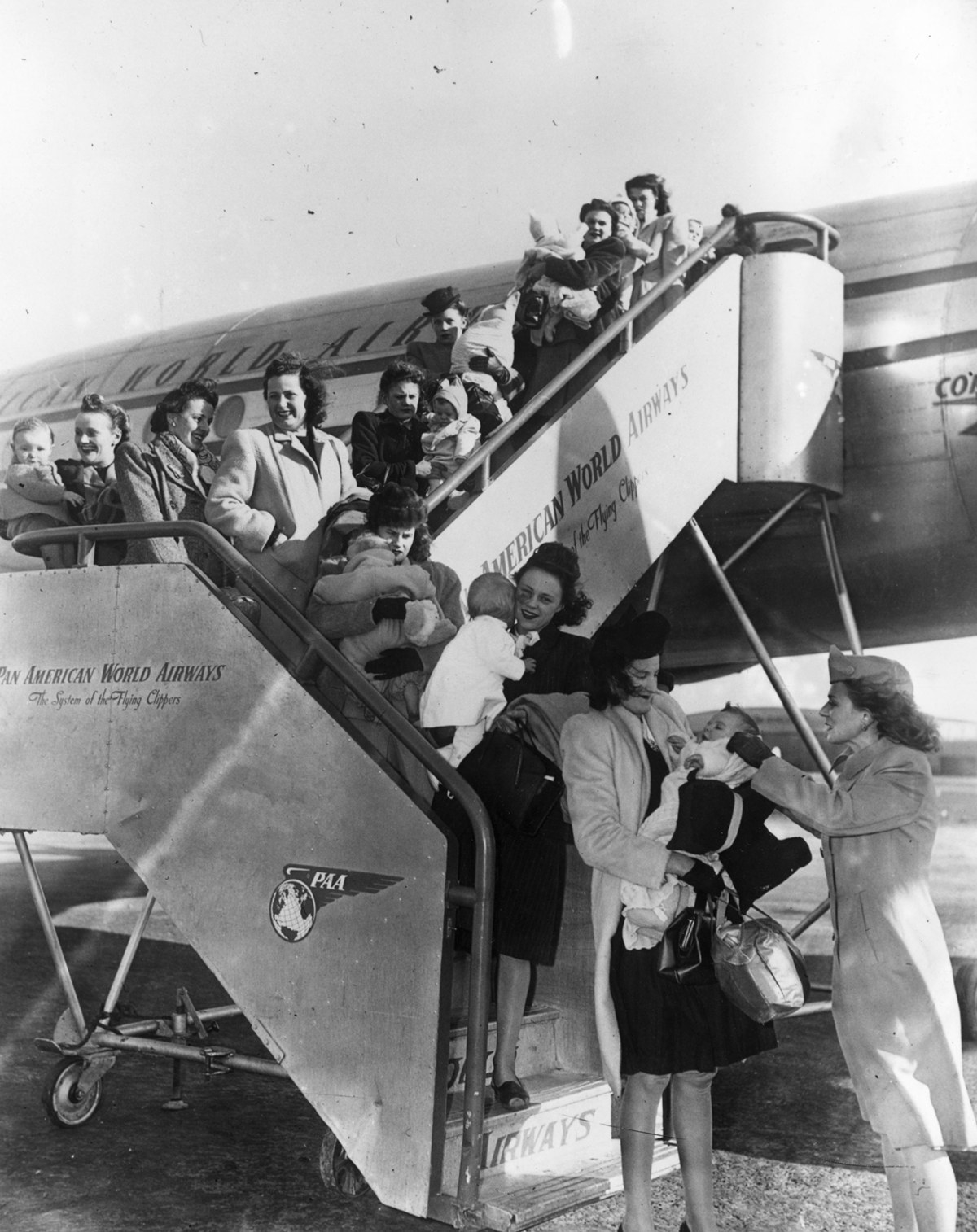 Military wives travelling with their babies arrive at LaGuardia Airport.