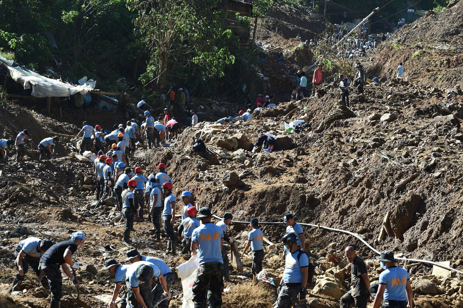 Rescuers dig at a landslide site where dozens of residents are believed to have been buried during heavy rains at the height of Typhoon Mangkhut in Itogon, Benguet province, the Philippines, on Sept. 18.