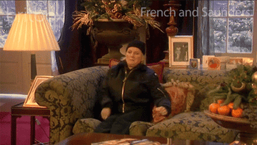 A gif of someone wiggling into a comfy sofa