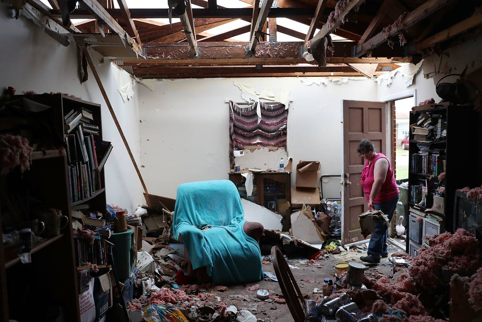 Amanda Logsdon begins the process of trying to clean up her home after its roof was blown off by Hurricane Michael on Oct. 11 in Panama City.