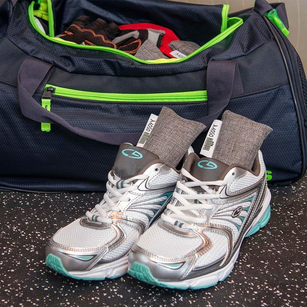 A shelf of shoes with the rectangular deodorizer fabric bags inside