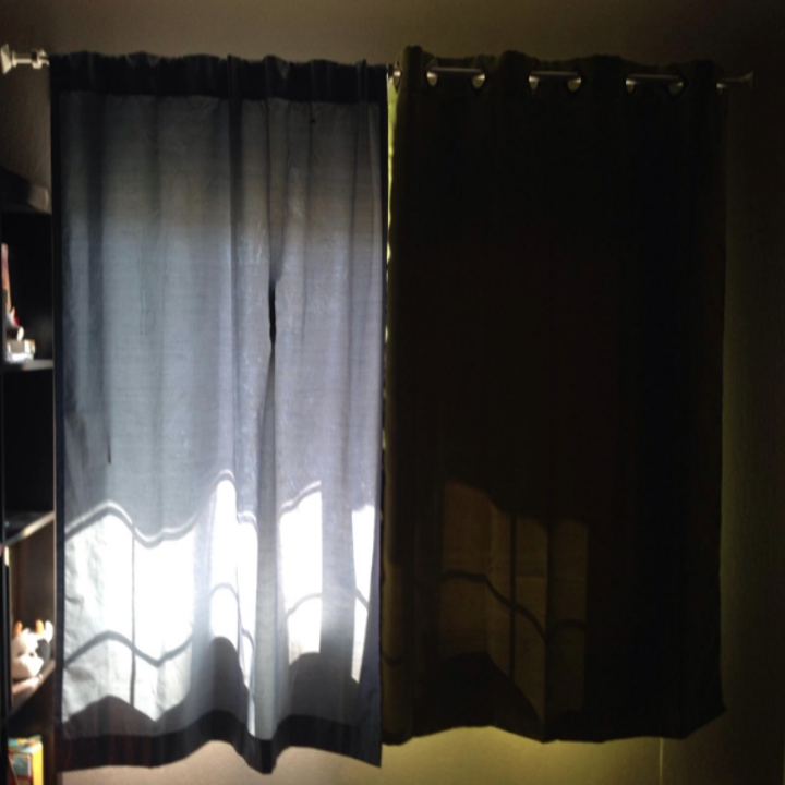 Reviewer photo with blackout curtains blocking lots of light beside their old curtains that did not block out the light