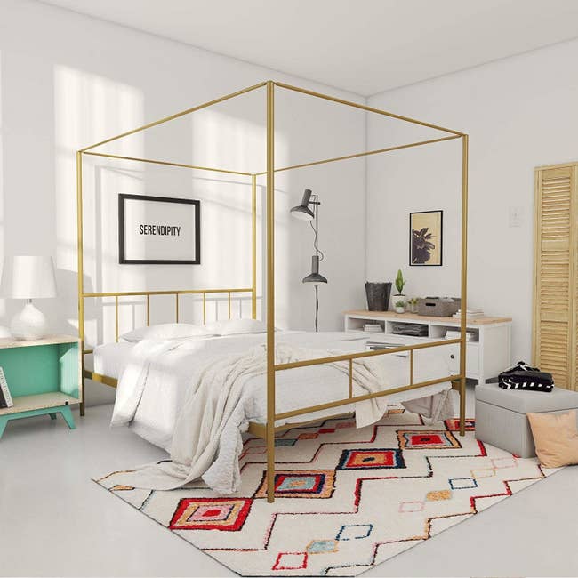 bedroom with gold tone canopy in squared off shape