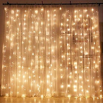 sheer curtain with strings of lights behind it