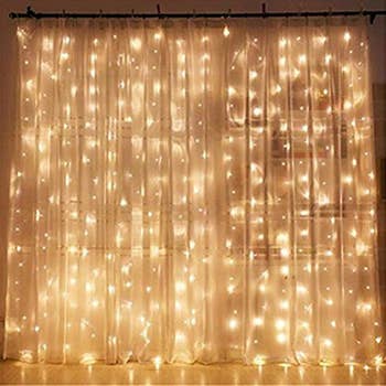 sheer curtain with strings of lights behind it
