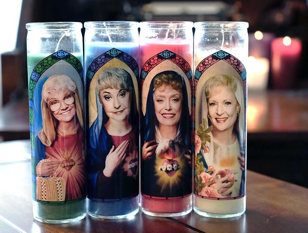 four prayer style candles with the golden girls characters as saints