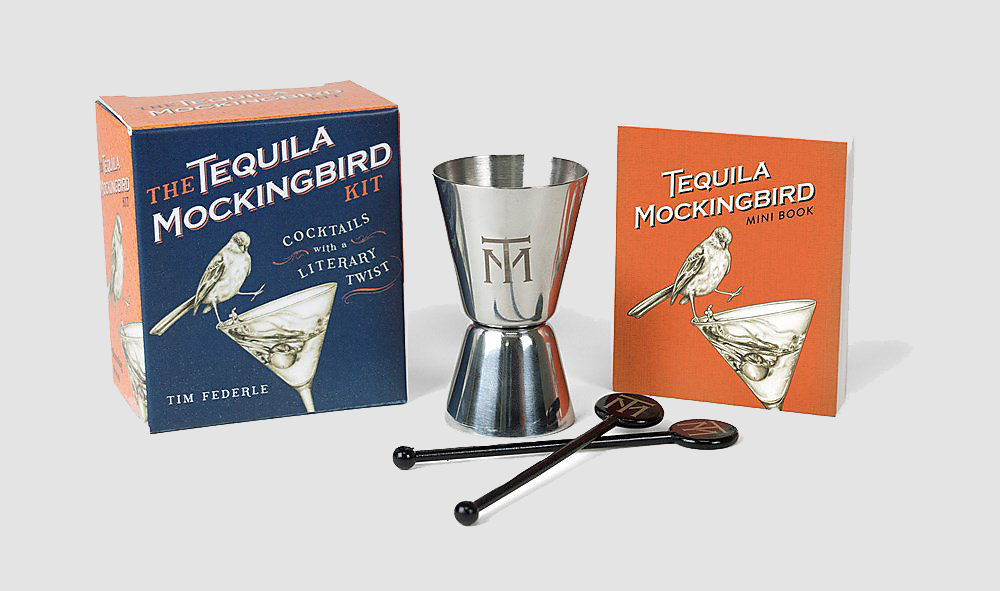 Product shot of the packaging, shot glass, stirrers, and tequila mockingbird book