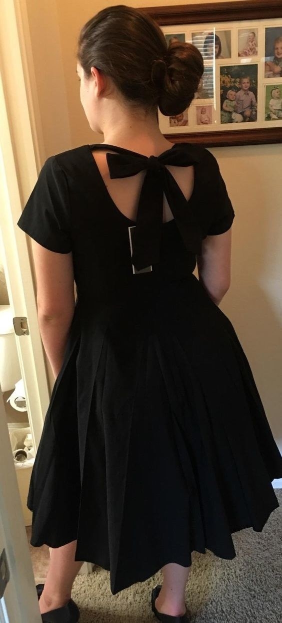 A reviewer in the black dress shown from the back